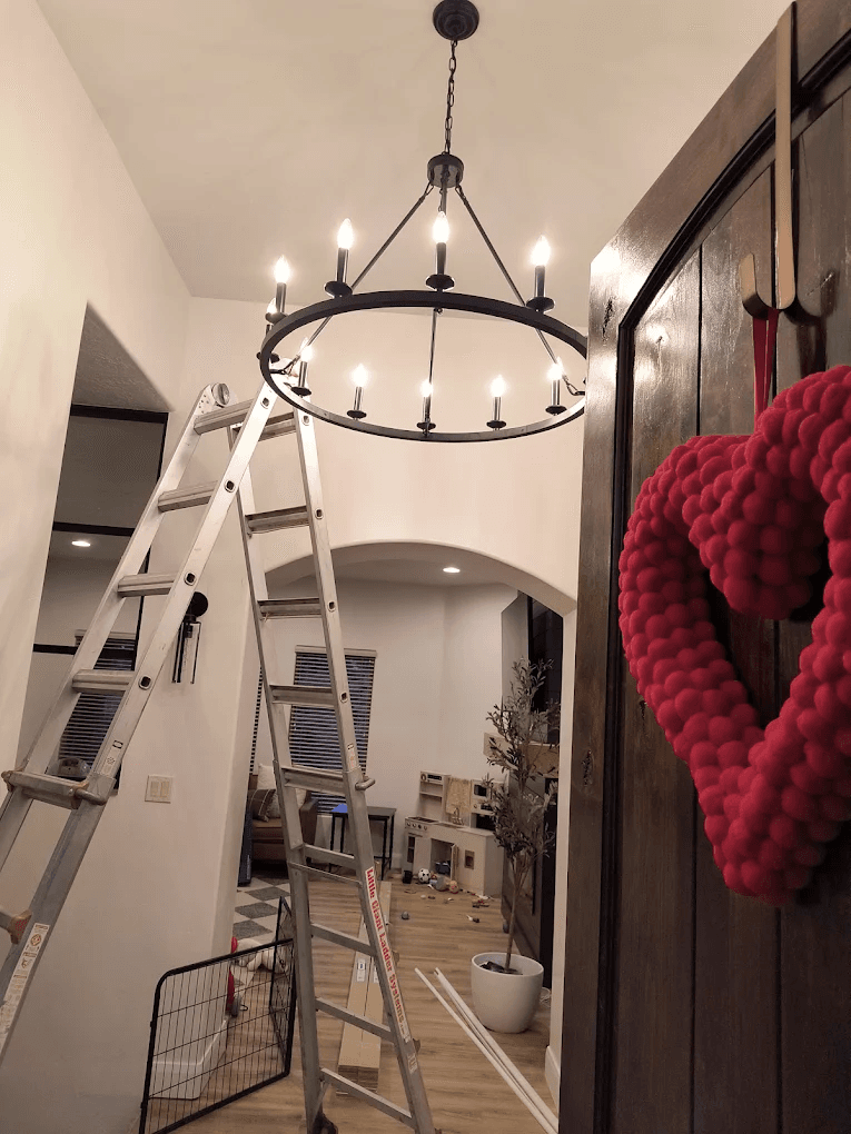 Ring chandelier installed in a vaulted entryway by High Desert Electric